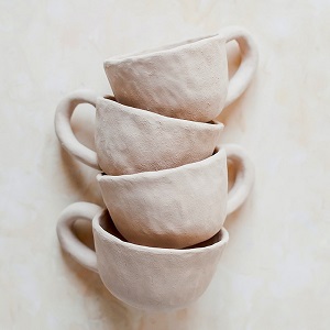 stacked white clay cups