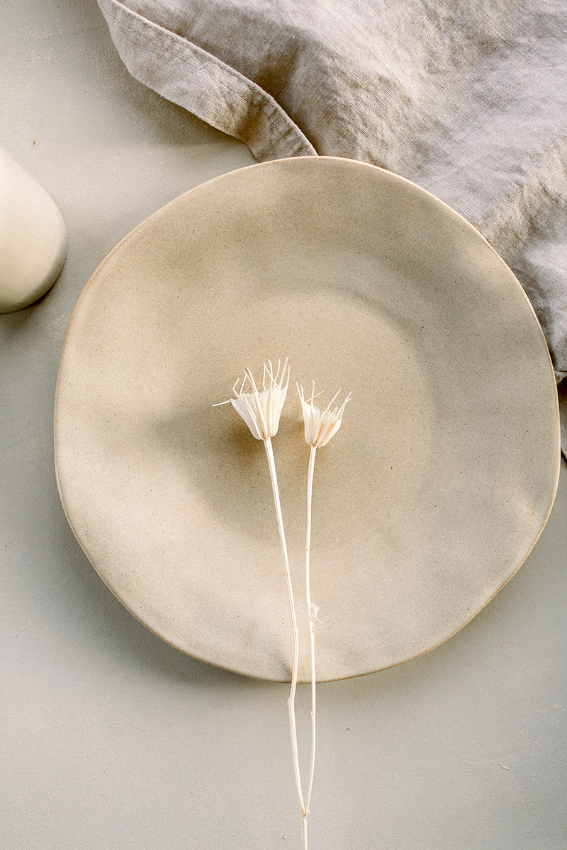beige plate with dry flowers
